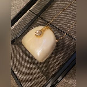 SOLD Vintage 1980’s Pearlescent white hard purse with gold chain shoulder strap.